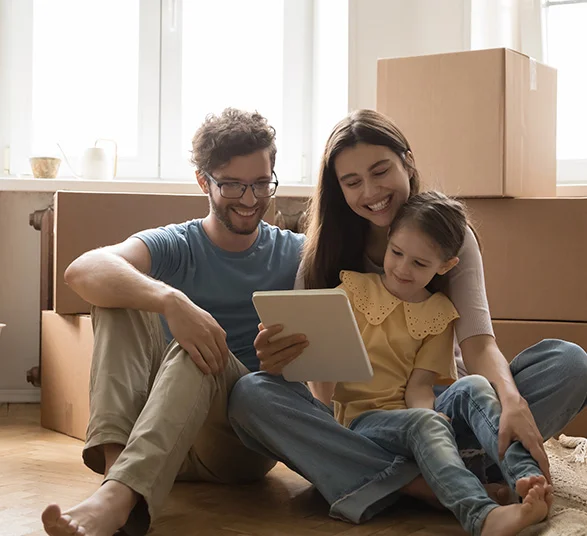 Family reviewing their moving plans on a tablet